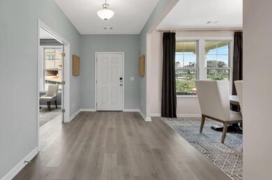 Foyer entrance with wood finished floors and baseboards