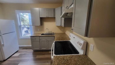Kitchen has gray cabinetry