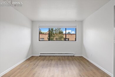 Spare room featuring light wood finished floors and a baseboard radiator