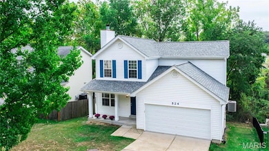 Traditional-style home featuring covered porch, roof with shingles, driveway, a chimney, and a garage