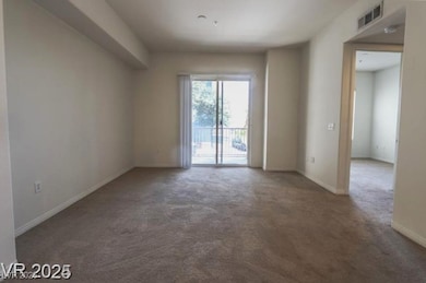 Carpeted empty room featuring baseboards and visib