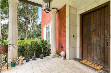 A massive solid wood door, with Merlin doorknocker, greets guests