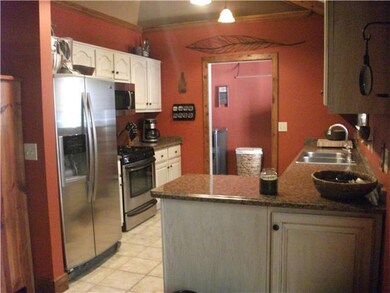 Kitchen with stainless appliances, lots of cabinet space, pretty countertops.  All appliances remain with the house!