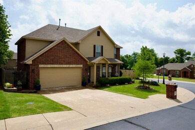 View of front of house featuring a garage and a front lawn
