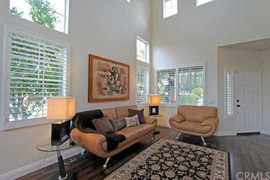 Formal Living room has vaulted ceilings, dark wood