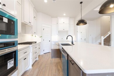 Room details featuring backsplash, light stone cou