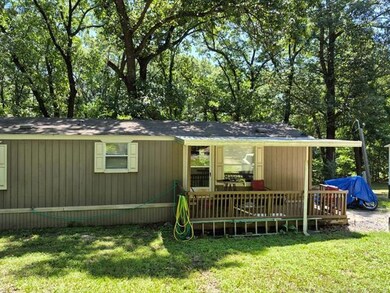 Back of house featuring a yard