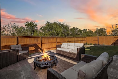 Patio terrace at dusk featuring a fenced backyard, an outdoor living space, and a patio area