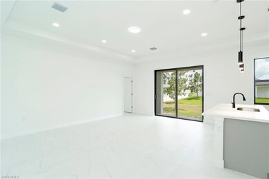 Unfurnished living room with a raised ceiling and recessed lighting