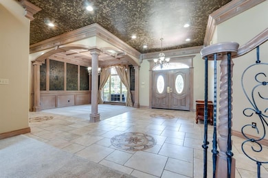 Tiled entrance foyer featuring french doors, ornam