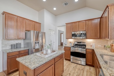Kitchen featuring backsplash, light wood-type flo