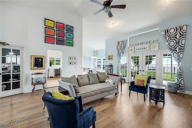 Living room featuring high vaulted ceiling, french