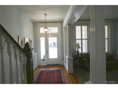 The original oak door has a beveled glass panel, l