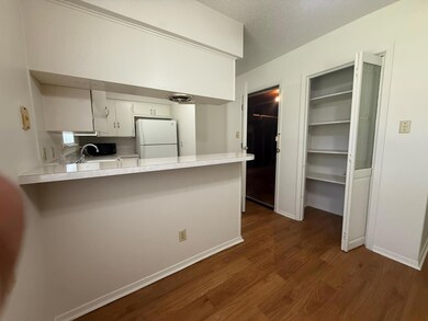 Kitchen featuring light countertops, dark wood-st