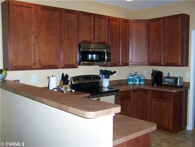 Kitchen - Cherry cabinets and stainless appliances