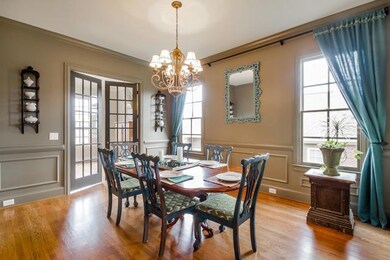Handsome and stylish dining room with custom paint with easy access to the kitchen and other living spaces. 