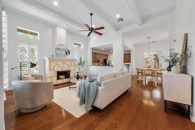 Living room featuring dark wood-style floors, hea