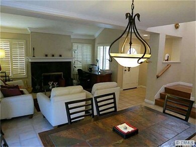 Formal living and dining room with fireplace.