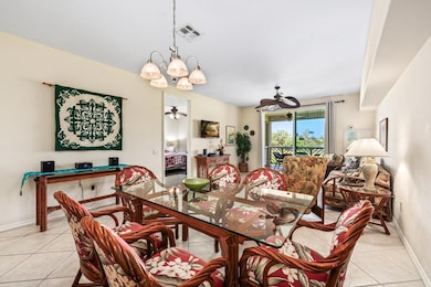 Dining and living area with lanai access and golf course views.