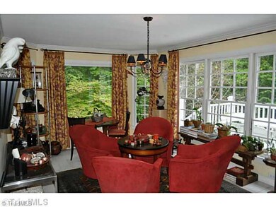 Sunroom. With windows on two sides this delightful sun room is always full of light, it to opens out to the grand porch.