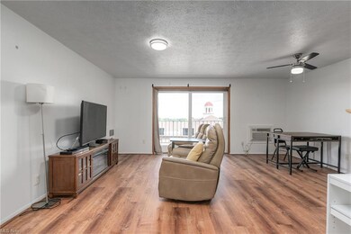 Hardwood floored living room featuring a textured 