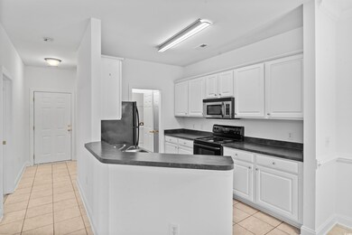 Kitchen featuring white cabinets, kitchen peninsul