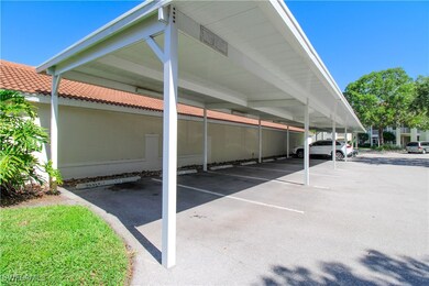 View of parking featuring a carport