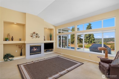 The propane fireplace anchors the room as the view captures your eyes.