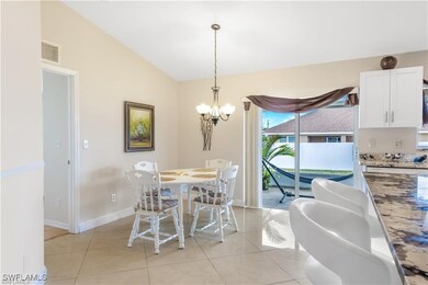 Dining space featuring a chandelier, light tile pa