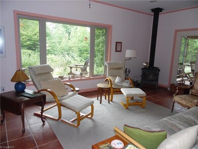 Large living room, picture window and wood stove with plenty of wood already cut and waiting for a cool evening.