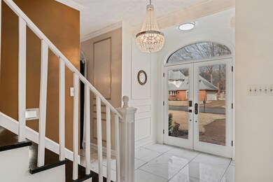 Foyer entrance with a notable chandelier, ornament