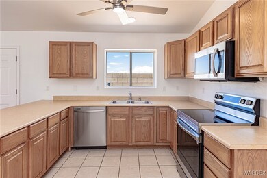 Kitchen with vaulted ceiling, light tile patterned