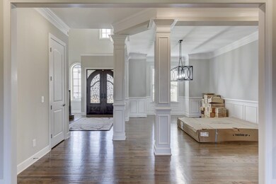 From the living room looking towards the formal dining. The hardwood flooring is true sand and finish floors. Notice the 10' ceilings and 8' doors on the main level.
