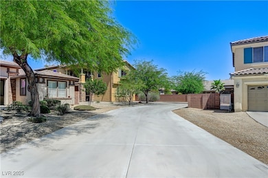 View of concrete driveway featuring a gate