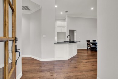 Kitchen featuring white cabinets, sink, ornamental