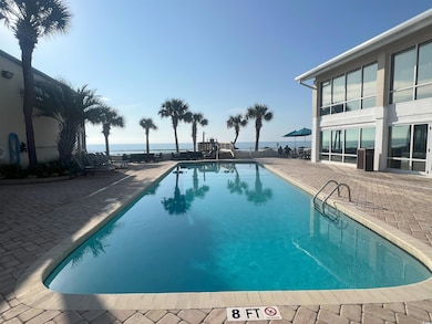 Pool with a patio and a water view