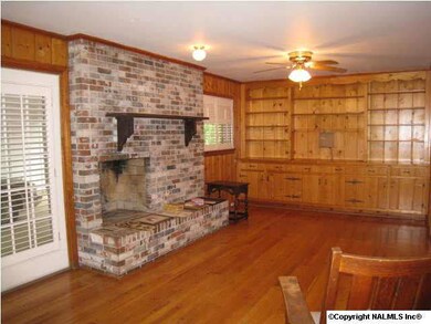 Den with fireplace and built-ins.