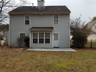 Back of property featuring a patio area and a chimney