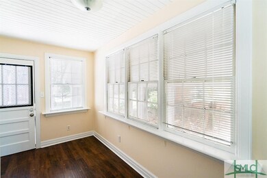 Fully enclosed porch office with exterior access.