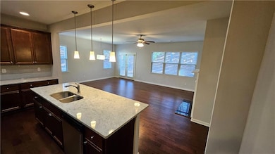 Kitchen with dark wood-style floors, ceiling fan, 