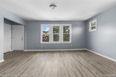 Unfurnished living room with light wood-style floors and plenty of natural light