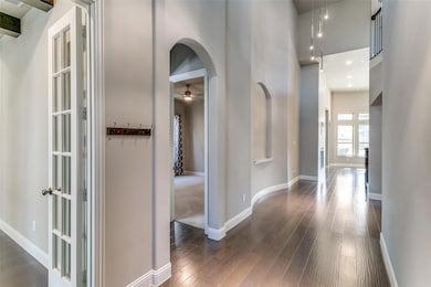 Entryway with soaring sealings and designer light fixture.