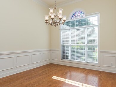 12 foot ceiling, crown molding, wainscoting, and triple window with transom and 1/2 round window.