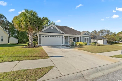 View of front of house featuring a front yard, a garage, and concrete driveway
