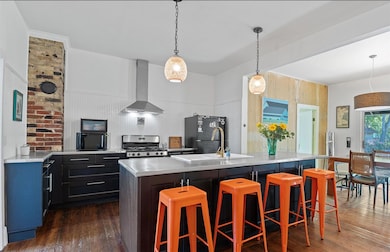 Kitchen featuring a kitchen breakfast bar, gas st
