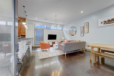 Living room with visible vents, a chandelier, con