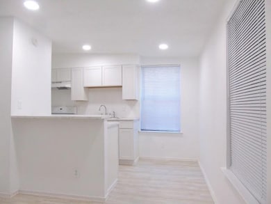 Kitchen featuring recessed lighting, light counte