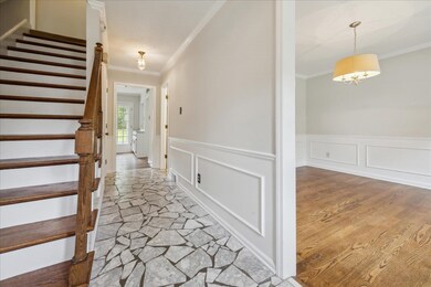 Hallway with light wood-type flooring and ornament