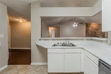Kitchen featuring white cabinets, light countertop