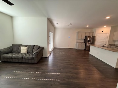 Living area featuring dark wood finished floors, recessed lighting, and ceiling fan
